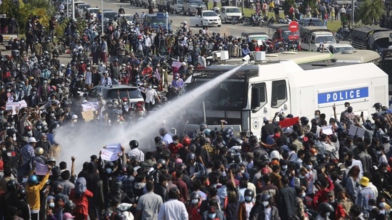 A police truck sprays water to a crowd of protesters in Naypyitaw on February 8. Tension in the confrontations between the authorities and demonstrators against last week's coup boiled over February 8 as police fired a water cannon at peaceful protesters in the capital.(AP)