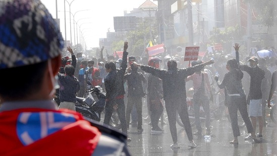 Protesters regroup after police fired warning-shots and used water cannons during a protest in Mandalay, on February 9.(AP)