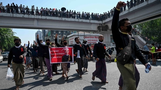 Protesters take part during a demonstration against the military coup in Yangon on February 9. Promises on Monday from junta leader General Min Aung Hlaing to eventually hold a new election in his first address since seizing power drew scorn. He repeated unproven accusations of fraud in the election which he used to justify the coup.(Ye Aung Thu / AFP)