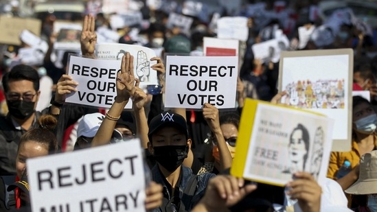 Demonstrators display placards during a protest against last week's coup in Yangon, on February 9. Protesters have continued to gather, breaching a new military orer banning public gatherings of five or more issued on February 8 and intended to crack down on peaceful public protests opposing their takeover.(AP)