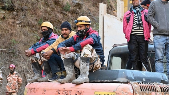 Rescue personnel rest on an excavator outside a tunnel blocked with debris during rescue operations in Tapovan of Chamoli district on February 8, 2021 following a flash flood thought to have been caused when a glacier burst on February 7. (AFP) Rescue personnel rest on an excavator outside a tunnel blocked with debris during rescue operations in Tapovan of Chamoli district on February 8, 2021 following a flash flood thought to have been caused when a glacier burst on February 7. (AFP)