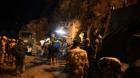Indian army and rescue teams stand outside the entrance of a tunnel blocked with mud and debris during rescue operations in Tapovan of Chamoli district.(AFP) Indian army and rescue teams stand outside the entrance of a tunnel blocked with mud and debris during rescue operations in Tapovan of Chamoli district.(AFP)