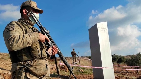 Turkish police officers guard a monolith, found on an open field near Sanliurfa, southeastern Turkey. The metal block was found by a farmer Friday in Sanliurfa province with old Turkic script that reads "Look at the sky, see the moon." The monolith, 3 meters high (about 10 feet), was discovered near UNESCO World Heritage site Gobeklitepe with its megalithic structures dating back to 10th millennium B.C. Turkish media reported Sunday that gendarmes were looking through CCTV footage and investigating vehicles that may have transported the monolith. Other mysterious monoliths have popped up and some have disappeared in numerous countries since 2020. (AP)