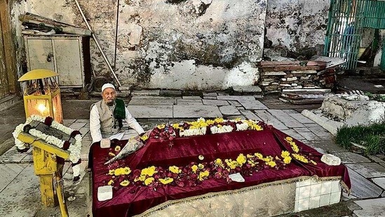 Mr Khan is sitting by a grave, alone. The shrine houses the grave of the aforementioned mystic as well as of other historical figures, famous and obscure, including a Mughal emperor.