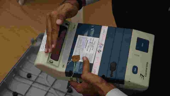 Polling official checks the control unit of an electronic voting machine at a dispatch center in Ahmadabad, India, (AP) Polling official checks the control unit of an electronic voting machine at a dispatch center in Ahmadabad, India, (AP)