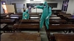 Employees in PPE kits sanitise a classroom at SIES College in Sion, Mumbai, on Wednesday. (Satish Bate/HT Photo) Employees in PPE kits sanitise a classroom at SIES College in Sion, Mumbai, on Wednesday. (Satish Bate/HT Photo)