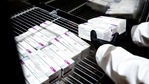 A health worker places packages containing doses of the AstraZeneca vaccine. (AP Photo) A health worker places packages containing doses of the AstraZeneca vaccine. (AP Photo)