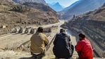 Villagers watch the rescue operations carried at Tapovan barrage, following the Sunday's glacier burst in Joshimath causing a massive flood in the Dhauli Ganga river, in Chamoli district of Uttarakhand, Wednesday. (PTI Photo ) Villagers watch the rescue operations carried at Tapovan barrage, following the Sunday's glacier burst in Joshimath causing a massive flood in the Dhauli Ganga river, in Chamoli district of Uttarakhand, Wednesday. (PTI Photo )
