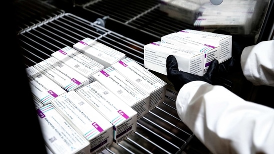 A health worker places packages containing doses of the AstraZeneca vaccine. (AP Photo) A health worker places packages containing doses of the AstraZeneca vaccine. (AP Photo)
