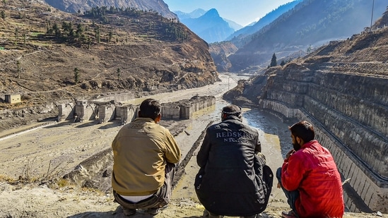 Villagers watch the rescue operations carried at Tapovan barrage, following the Sunday's glacier burst in Joshimath causing a massive flood in the Dhauli Ganga river, in Chamoli district of Uttarakhand, Wednesday. (PTI Photo )