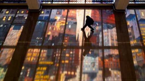 A person walks though colorful patterns, Monday, Feb. 8, 2021, cast from windows in Terminal B of LaGuardia Airport in New York. (AP File Photo) A person walks though colorful patterns, Monday, Feb. 8, 2021, cast from windows in Terminal B of LaGuardia Airport in New York. (AP File Photo)