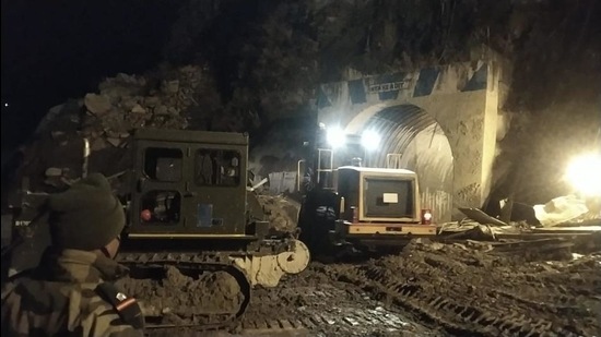Heavy machinery clears muck from Tapovan tunnel at the NTPC dam site on Tuesday evening. (HT Photo)
