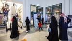 People exit a shopping mall as it closes early according to government-imposed Covid-19 coronavirus pandemic restrictions in Kuwait City.(AP) People exit a shopping mall as it closes early according to government-imposed Covid-19 coronavirus pandemic restrictions in Kuwait City.(AP)