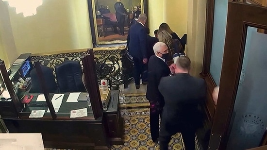 A security video shows vice president Mike Pence being evacuated as rioters breach the Capitol.(AP)