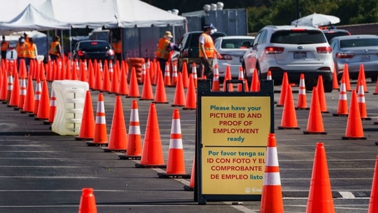 Motorists are screened as they line up for a Covid-19 vaccine appointment at the mass vaccination site at the parking lot of L.A. County Office of Education headquarters in Downey, California. (AP) Motorists are screened as they line up for a Covid-19 vaccine appointment at the mass vaccination site at the parking lot of L.A. County Office of Education headquarters in Downey, California. (AP)