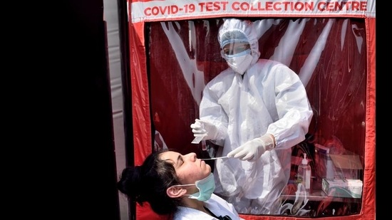 A health worker collects swab sample of a resident at BKC in Mumbai on Thursday. (Satish Bate/HT Photo) A health worker collects swab sample of a resident at BKC in Mumbai on Thursday. (Satish Bate/HT Photo)