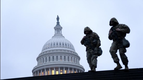 Members of the National Guard walk past the US Capitol building in Washington, DC on February 11. (Bloomberg)
