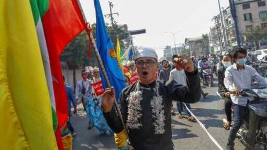Demonstrators with Myanmar national flags shout slogans against the military coup during a protest march in Mandalay, (AP) Demonstrators with Myanmar national flags shout slogans against the military coup during a protest march in Mandalay, (AP)
