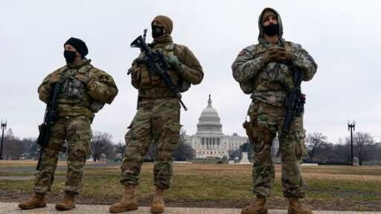US Army National Guard stand their posts as they guard the perimeter of the Capitol, (AP)