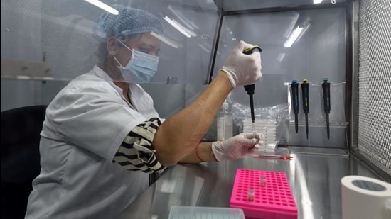 A healthcare worker tests samples in newly launched Spice Health portable RT-PCR testing laboratory at BKC in Mumbai on Thursday. (Satish Bate/HT Photo) A healthcare worker tests samples in newly launched Spice Health portable RT-PCR testing laboratory at BKC in Mumbai on Thursday. (Satish Bate/HT Photo)