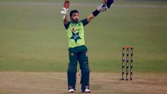 Pakistan's Mohammad Rizwan raises bat and helmet to celebrate his century during the 1st Twenty20 cricket match between Pakistan and South Africa at the Gaddafi Stadium, in Lahore, Pakistan, Thursday, Feb. 11, 2021. (AP)