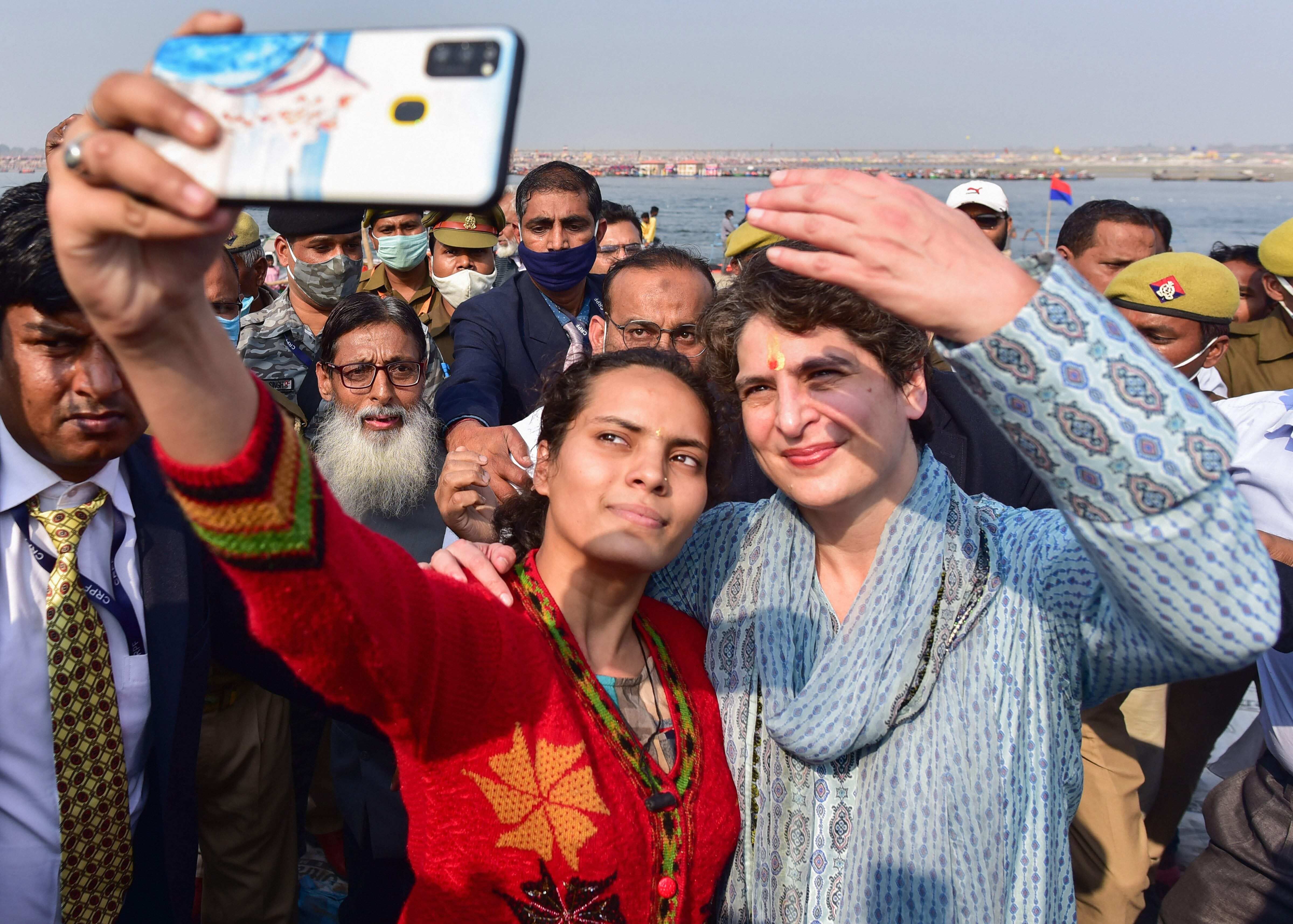 Congress General Secretary Priyanka Gandhi gets a selfie clicked after taking a holy dip at Sangam, confluence of River Ganga, Yamuna and Saraswati, on 'Mauni Amavasya' during the ongoing annual 'Magh Mela' festival in Prayagraj, Thursday, Feb. 11, 2021. (PTI)