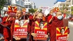 Buddhist monks display pictures of deposed leader Aung San Suu Kyi during a street march against the military coup in Mandalay, Myanmar on Friday, Feb. 12, 2021.(AP) Buddhist monks display pictures of deposed leader Aung San Suu Kyi during a street march against the military coup in Mandalay, Myanmar on Friday, Feb. 12, 2021.(AP)