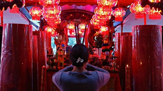 A worshipper holding incense sticks prays during the Lunar New Year's eve at a temple in Jakarta, Indonesia on February 11. The Lunar New Year is celebrated to mark the first new moon of the lunisolar calendars followed by Asian countries like China, South Korea, Vietnam and more.(Ajeng Dinar Ulfiana / REUTERS)