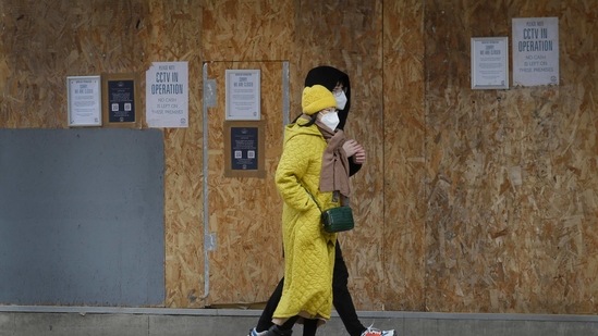 People walk past a boarded up nightclub near Leicester Square in central London, Thursday, Feb. 11, 2021. People are advised to stay at home to stay safe due to the coronavirus pandemic. (AP Photo/Kirsty Wigglesworth)(AP) People walk past a boarded up nightclub near Leicester Square in central London, Thursday, Feb. 11, 2021. People are advised to stay at home to stay safe due to the coronavirus pandemic. (AP Photo/Kirsty Wigglesworth)(AP)