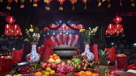 Offerings are placed on a table at the Boen San Bio temple on the eve of Lunar New Year in Tangerang, Indonesia on February 11. As per the Chinese zodiac, this marks the year of the Ox, bidding farewell to the year of the Rat.(Adek Berry / AFP)