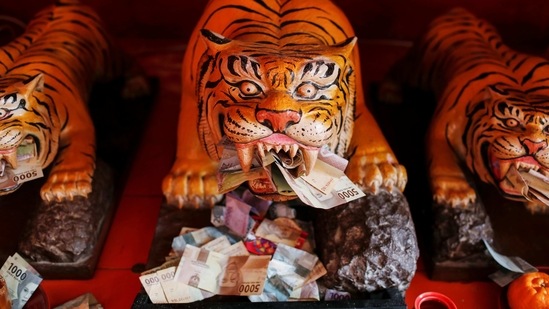 Banknotes are seen on Tiger sculptures at Dharma Bhakti temple during the Lunar New Year celebrations in Jakarta, Indonesia on February 12.(Willy Kurniawan / REUTERS)