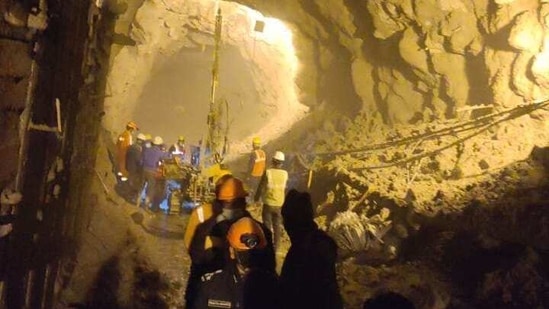 Rescue workers drilling inside the tunnel on Friday.(HT Photo )