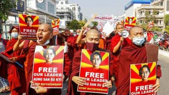 Buddhist monks display pictures of deposed leader Aung San Suu Kyi during a street march against the military coup in Mandalay, Myanmar on Friday, Feb. 12, 2021.(AP) Buddhist monks display pictures of deposed leader Aung San Suu Kyi during a street march against the military coup in Mandalay, Myanmar on Friday, Feb. 12, 2021.(AP)