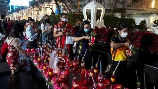 People pray during a religious ceremony at Phra Trimurti shrine, the God of Love to wish for luck in searching for soulmates ahead of Valentine's Day at Bangkok's shopping district, Thailand, February 11, 2021. (REUTERS)
