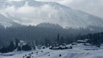 A view of snow-covered mountains and houses in a ski resort in Gulmarg, Srinagar, on January 25, 2021. (AFP) A view of snow-covered mountains and houses in a ski resort in Gulmarg, Srinagar, on January 25, 2021. (AFP)