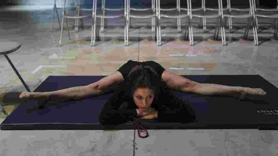 Performer Alice Rende from Brazil stretches prior to performing "Passages", a contortionism creation in a space delimited by a Plexiglas box during the BIAC, International Circus Arts Biennale, in Marseille, south of France, Thursday, Feb. 4, 2021.(AP)