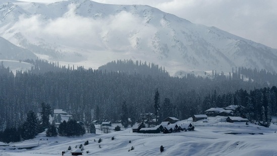 A view of snow-covered mountains and houses in a ski resort in Gulmarg, Srinagar, on January 25, 2021. (AFP)
