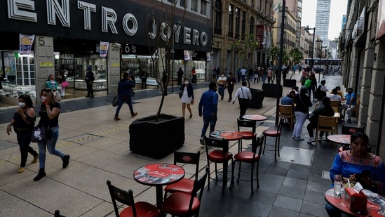 Diners eat at tables on the pedestrian walkway Madero, where temporary pandemic rules have allowed street tables and retail displays, in central Mexico City, Friday, Feb. 12, 2021. (AP) Diners eat at tables on the pedestrian walkway Madero, where temporary pandemic rules have allowed street tables and retail displays, in central Mexico City, Friday, Feb. 12, 2021. (AP)