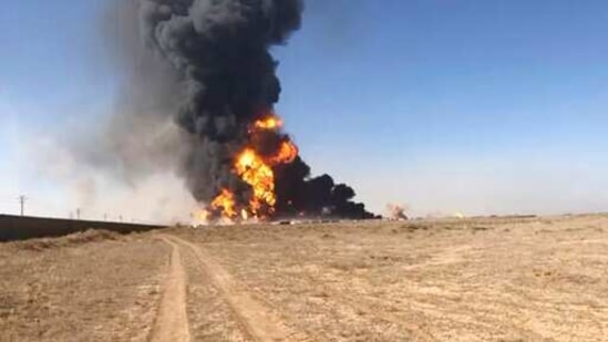 Smoke rises from fuel tankers at the Islam Qala border with Iran, in Herat Province, west of Kabul, Afghanistan. (AP) Smoke rises from fuel tankers at the Islam Qala border with Iran, in Herat Province, west of Kabul, Afghanistan. (AP)