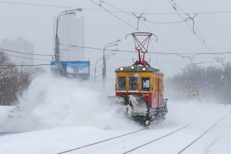 A maintenance tram removes snow from a track during heavy snowfall in Moscow, Russia February 13, 2021. (REUTERS)