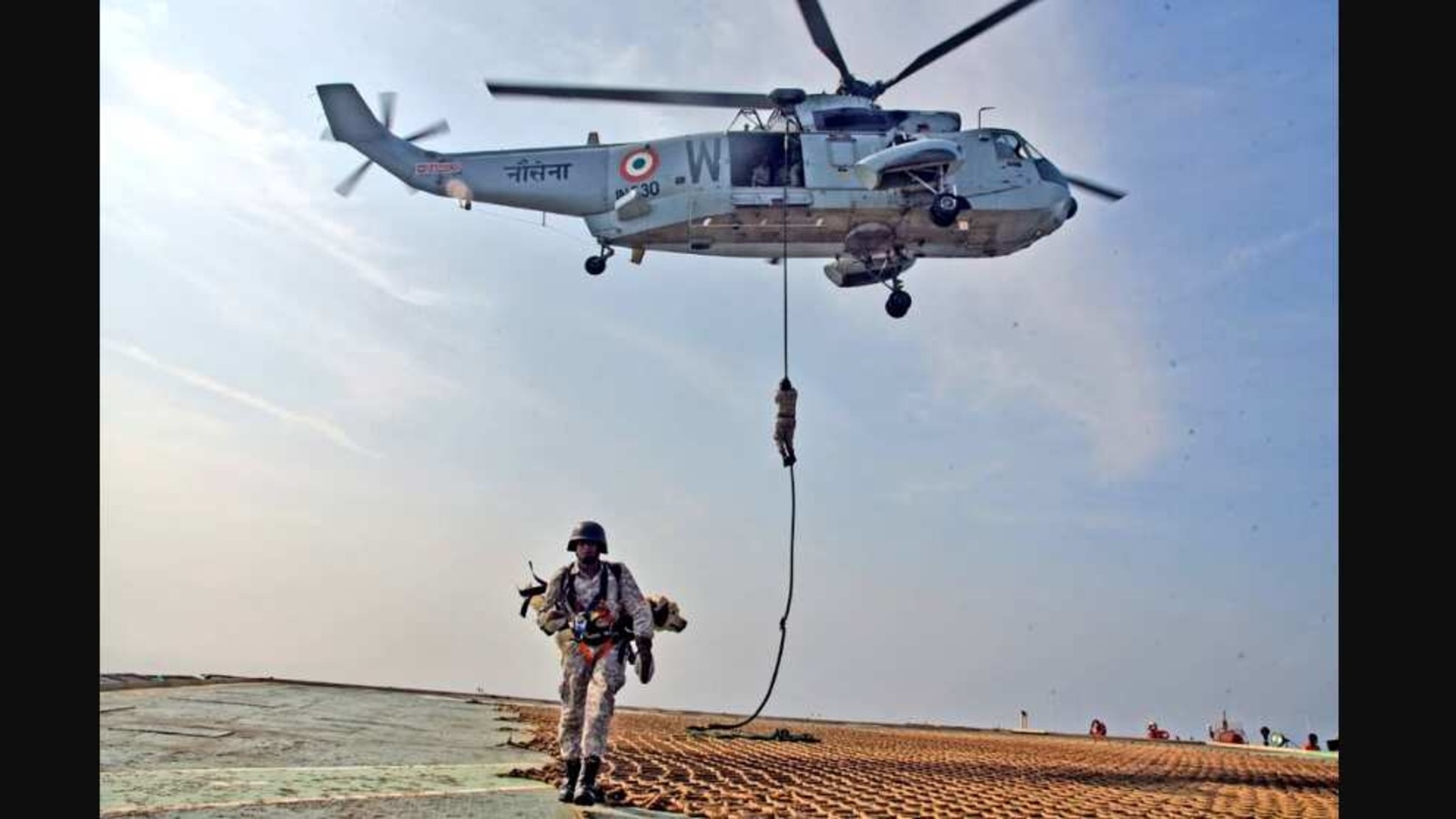 In a first, navy divers slither down from chopper with sniffer dogs. Watch
