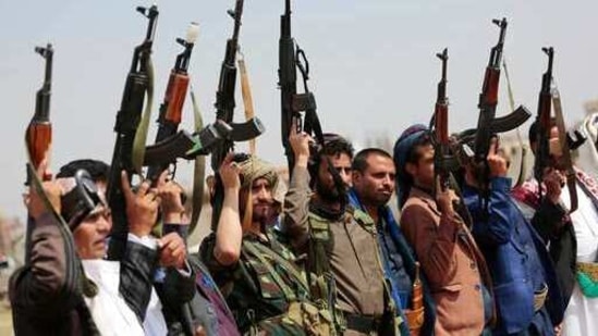 Tribesmen loyal to Houthi rebels raise their weapons during a gathering.(File photo / AP)