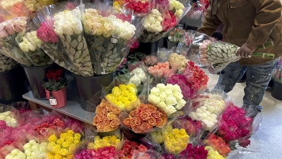A shopper at a Chicago area grocery store looks over Valentine's Day flowers Saturday, Feb. 13, 2021.( AP)