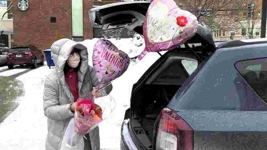 Ellen Yun loads Valentine's Day gifts for her mom, sister and brother in-laws, nephew and her two children Saturday, Feb. 13, 2021, outside a Chicago area grocery store. Yun said she had shopped for her husband earlier.( AP)
