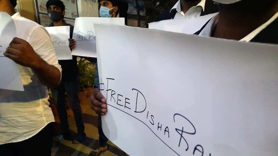 Students and supporters of activist Disha Ravi hold placards during a protest in support of activist Disha Ravi and asked how she allowed arresting by Delhi police, in Bengaluru on Sunday. (ANI Photo) Students and supporters of activist Disha Ravi hold placards during a protest in support of activist Disha Ravi and asked how she allowed arresting by Delhi police, in Bengaluru on Sunday. (ANI Photo)