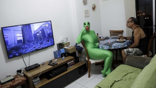 Teacher Juliana Motta, 34, with a family member while in a costume which she would have worn to this year’s Carnival celebrations in Rio de Janeiro, on February 9. "It is sad, but it's necessary, it is a necessary temporary evil, it hurts but it is transient" Motta told Reuters about not having Carnival celebrations.(Ricardo Moraes / REUTERS)