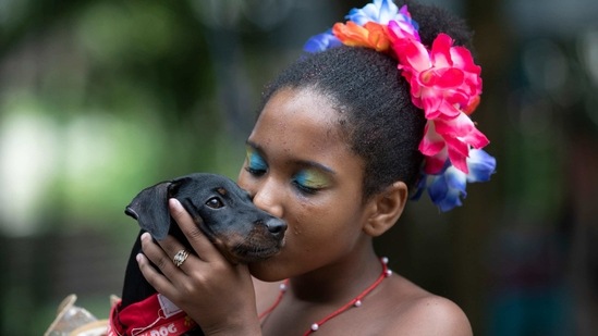 Sofia, 11, kisses her pet dog Sandy at the annual dog Carnival parade in Rio de Janeiro, Brazil. (AP) Sofia, 11, kisses her pet dog Sandy at the annual dog Carnival parade in Rio de Janeiro, Brazil. (AP)