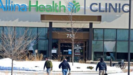 Law enforcement personnel walk toward the Allina Health clinic where multiple people were shot in Buffalo, Minnesota. (AP) Law enforcement personnel walk toward the Allina Health clinic where multiple people were shot in Buffalo, Minnesota. (AP)