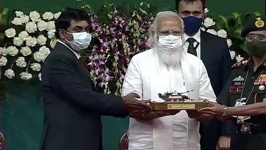 PM Modi handing over a model of Arjun Main Battle tank (MK-1A) to Army chief MM Naravane in Chennai on Sunday.(ANI Photo)