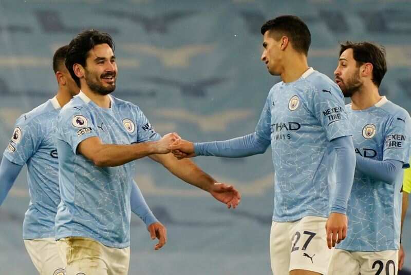 Manchester City's Ilkay Gundogan celebrates scoring their second goal with Joao Cancelo and Bernardo Silva. (Pool via REUTERS)